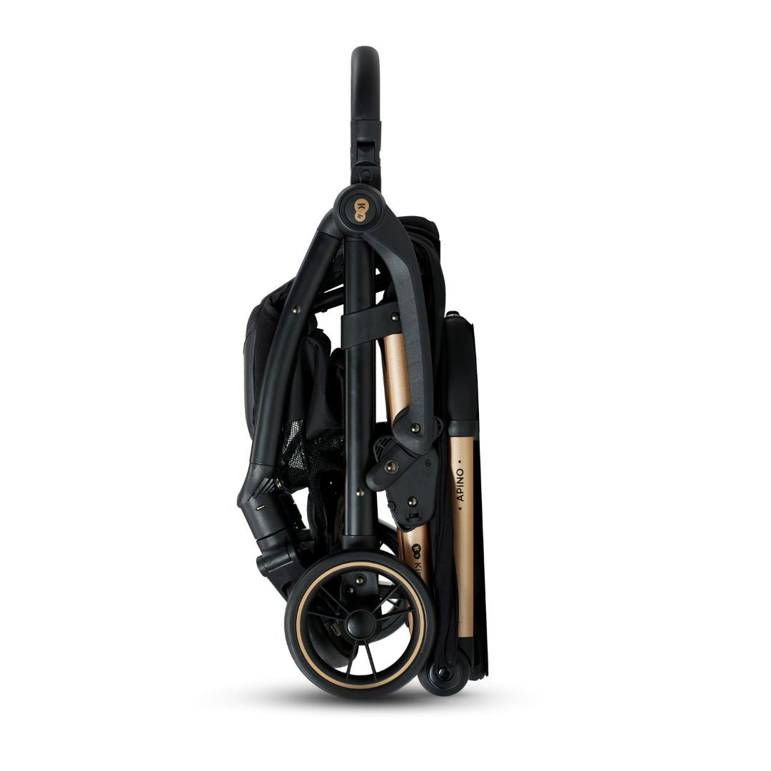 Coche de paseo Kinderkraft APINO negro plegado de pie con sistema AUTO FOLDING, estructura compacta con detalles dorados, vista lateral